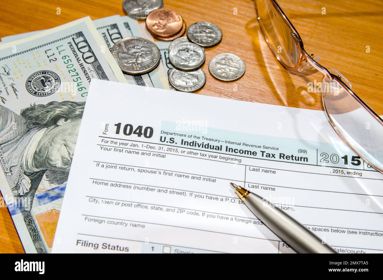 deadline time of 1040 tax form for 2016 with dollar and pen Stock Photo