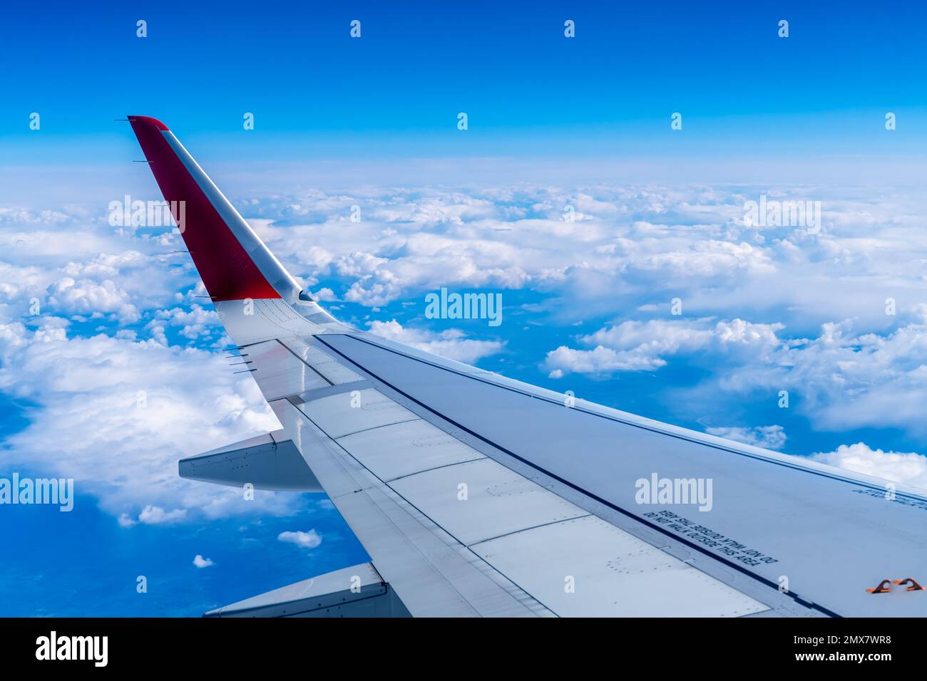 the wing of the aircraft against the sky and white clouds Stock Photo ...