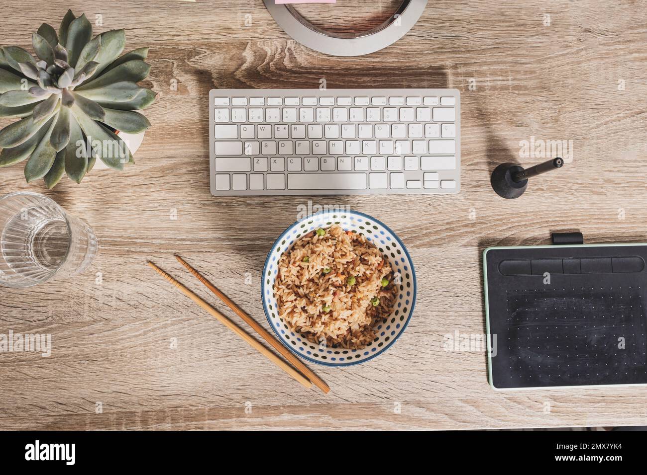 Top view of a bowl of oriental rice on the background of the work table. Time to enjoy lunch at work Stock Photo