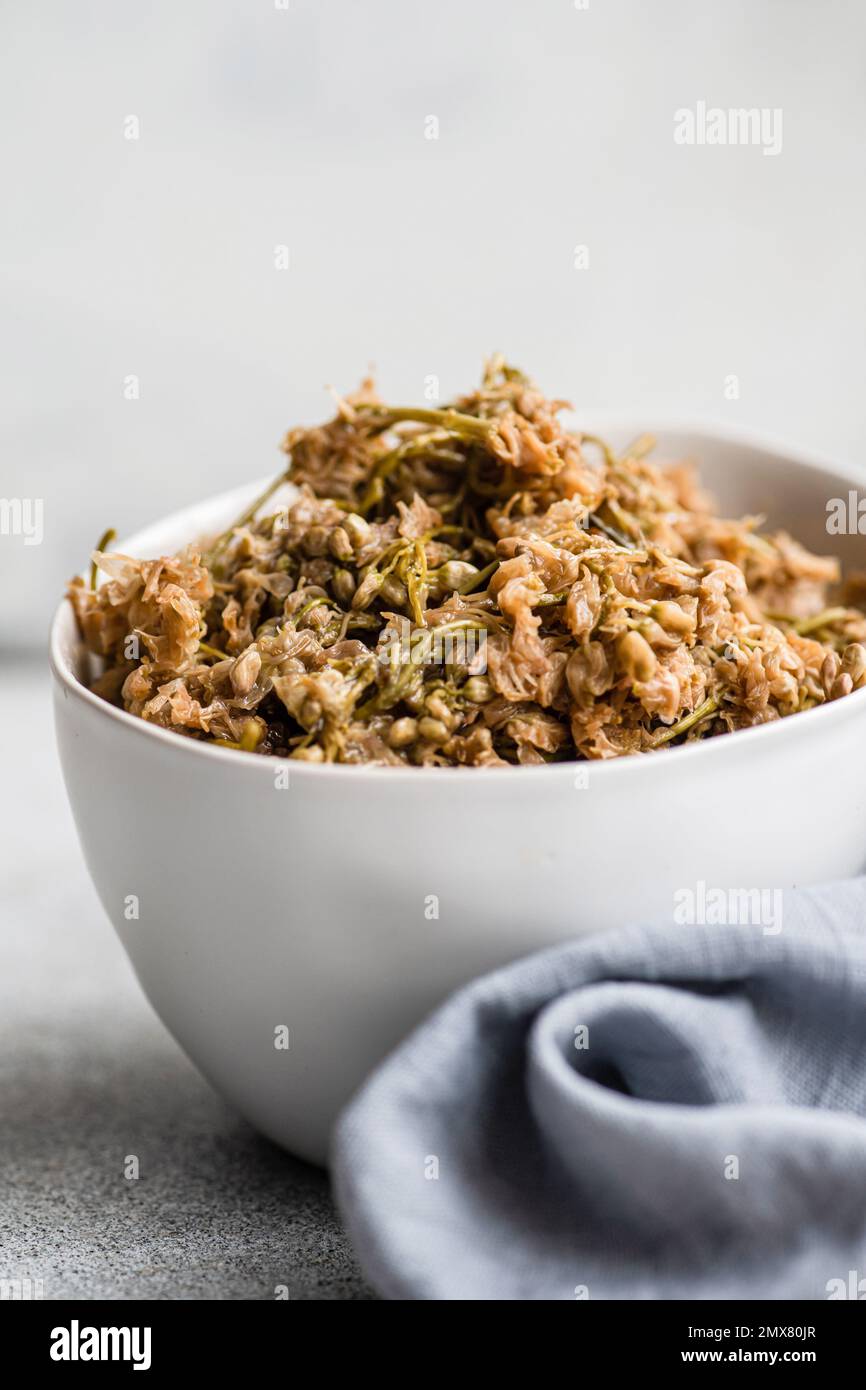 Traditional georgian fermented bladdernut blossom knows as a jonjoli, served in a bowl on concrete table Stock Photo