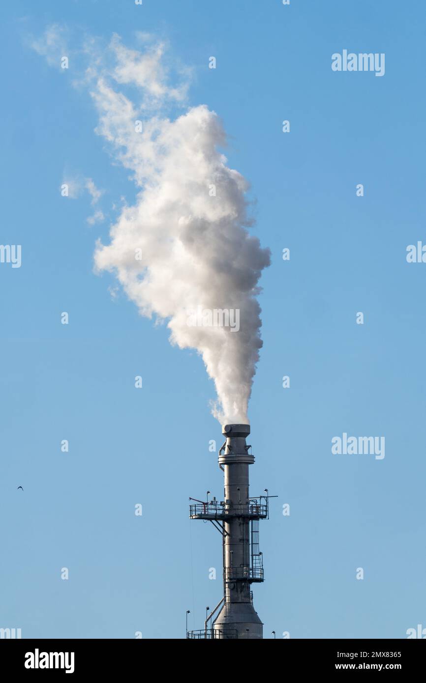 Steam comes from a tower in oil refinery near Salt Lake City, Utah ...