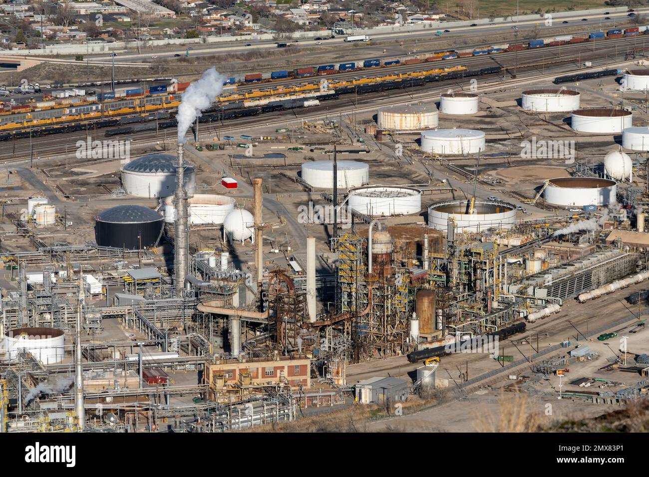 An oil refinery and oil storage tanks near Salt Lake City, Utah. Behind are railyards. Steam