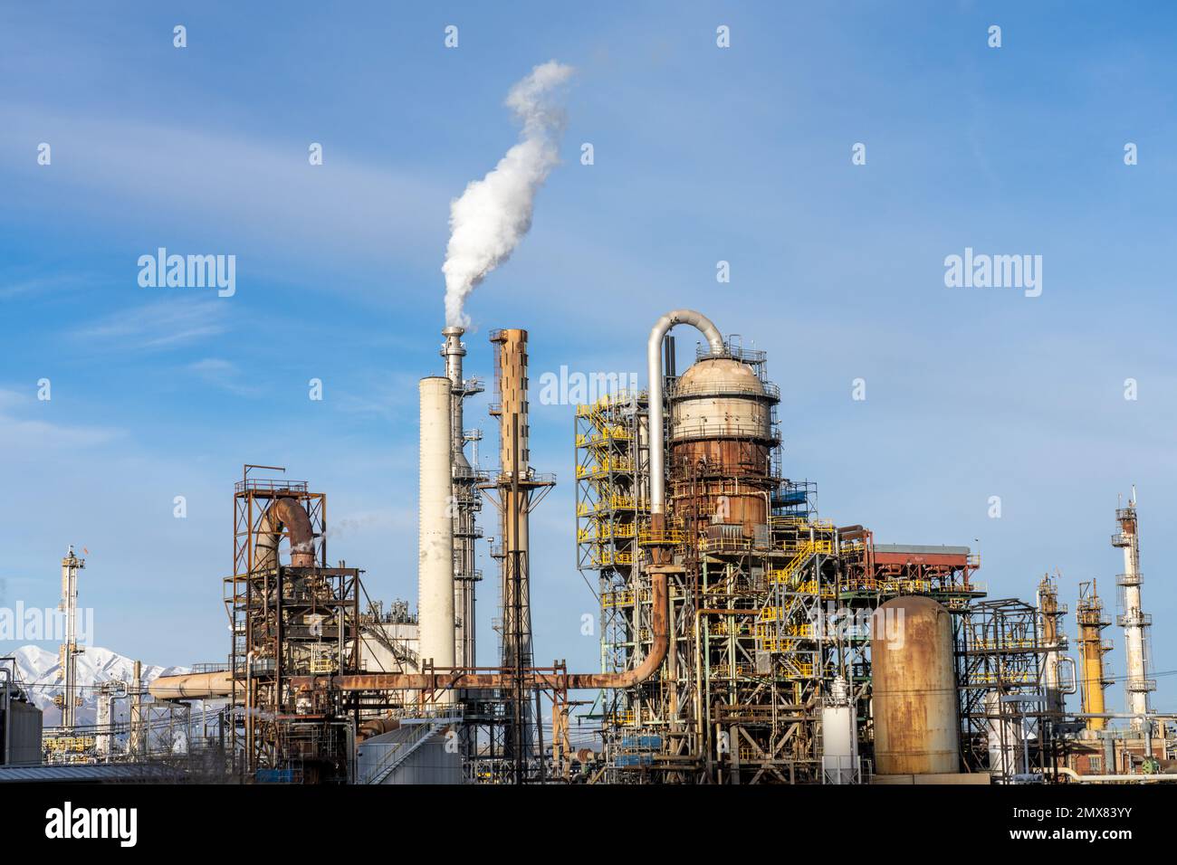 Steam comes from a tower in oil refinery with an FCCU or Fluid Catalytic Cracking Unit at right