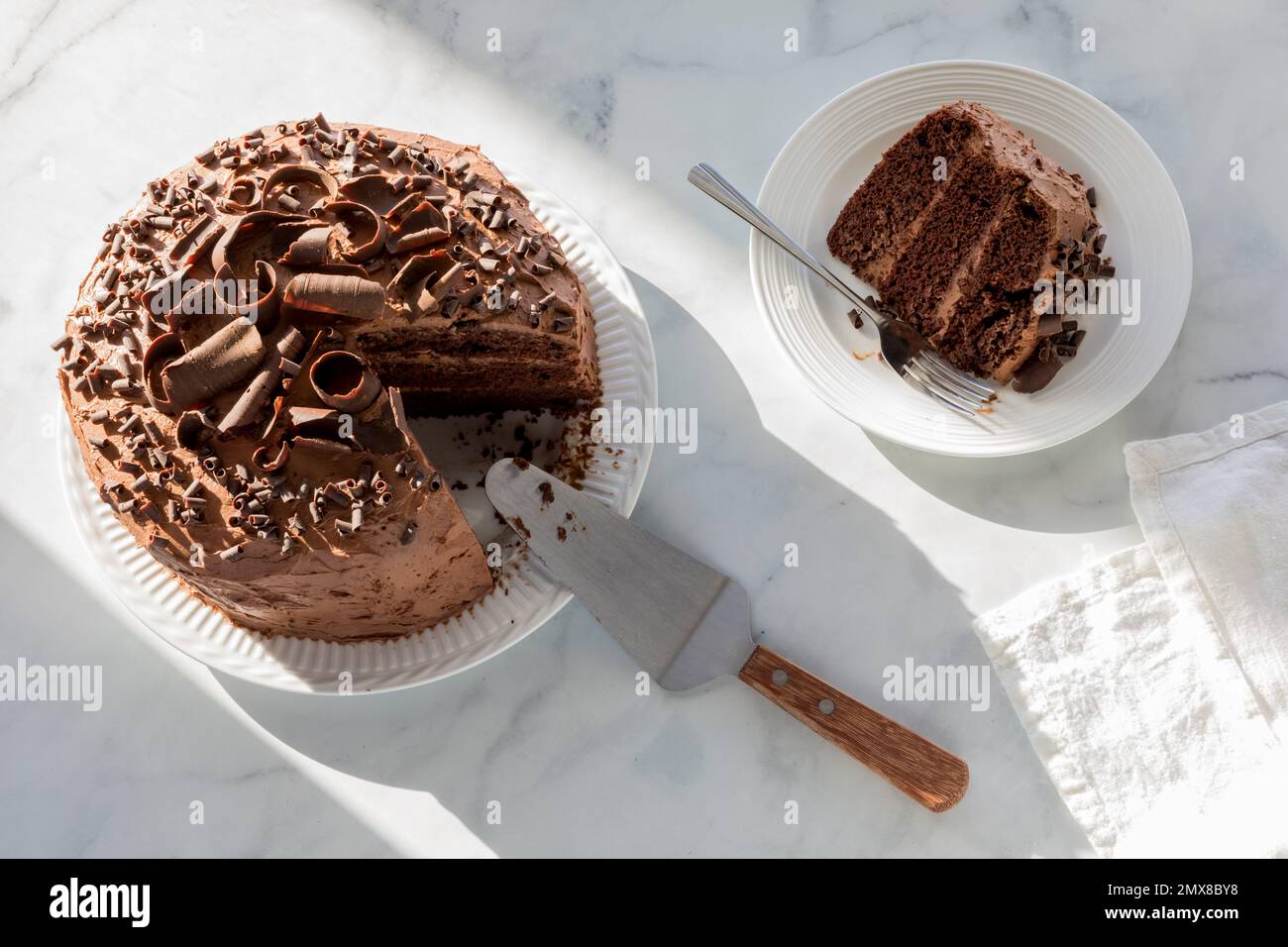 A low sugar and low carb homemade chocolate cake, in bright sunlight. Stock Photo