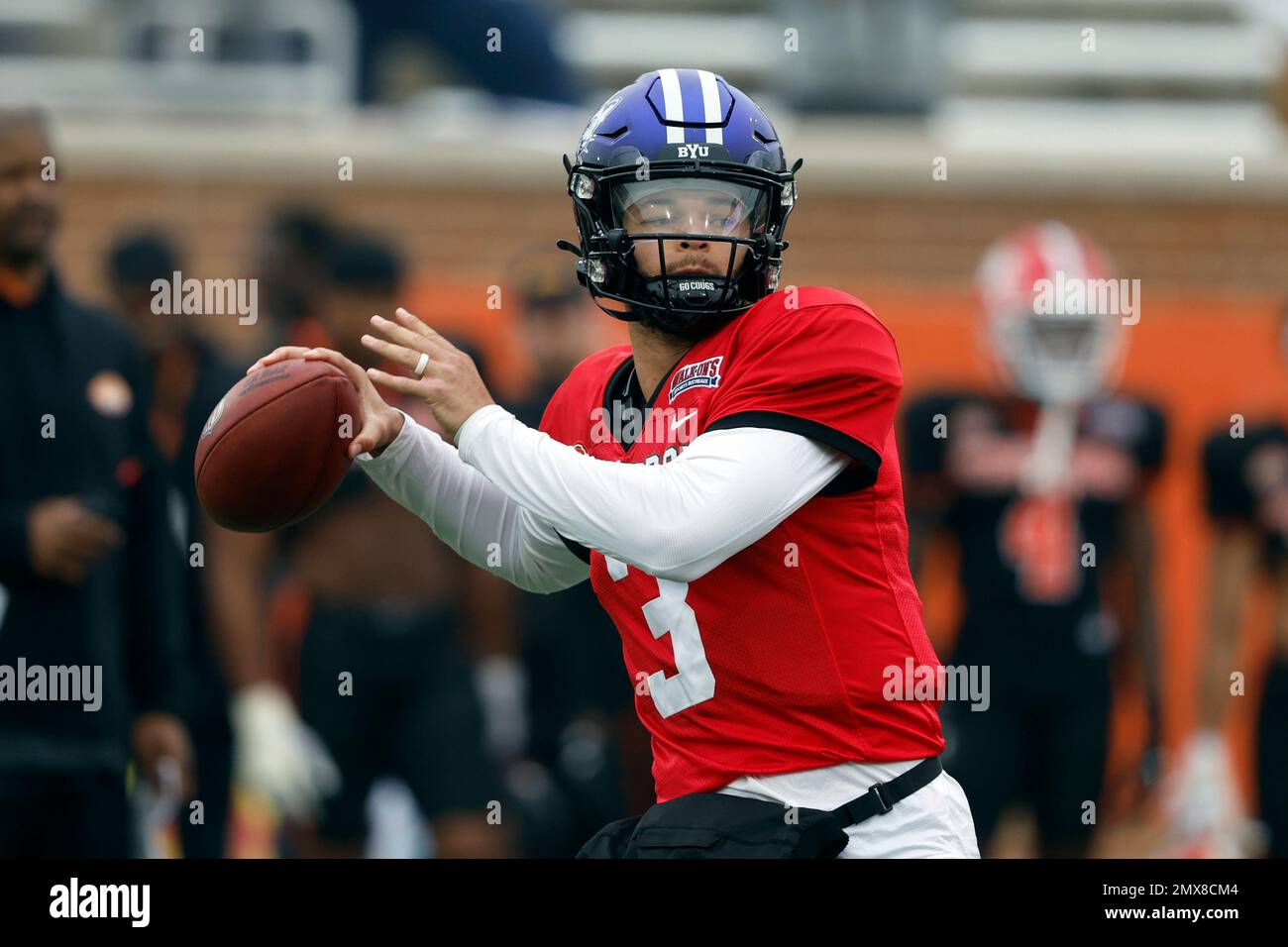 National quarterback Jaren Hall of BYU throws a pass during practice for the Senior Bowl NCAA