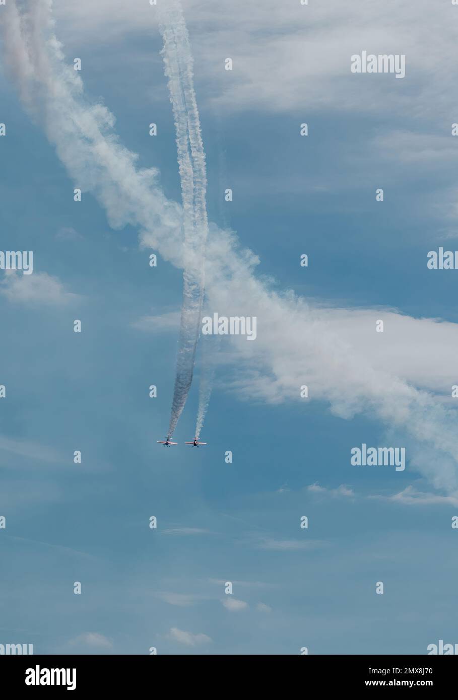 two small planes fly parallel to each other in a downward trajectory