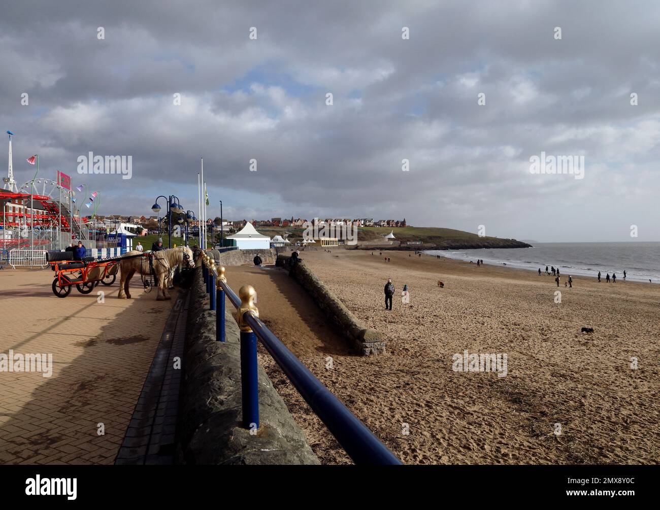 Ponies pulling training carts (Sulky, roadsters) tethered to the promenade railings at Barry Island beach. January 2023. Winter. Stock Photo