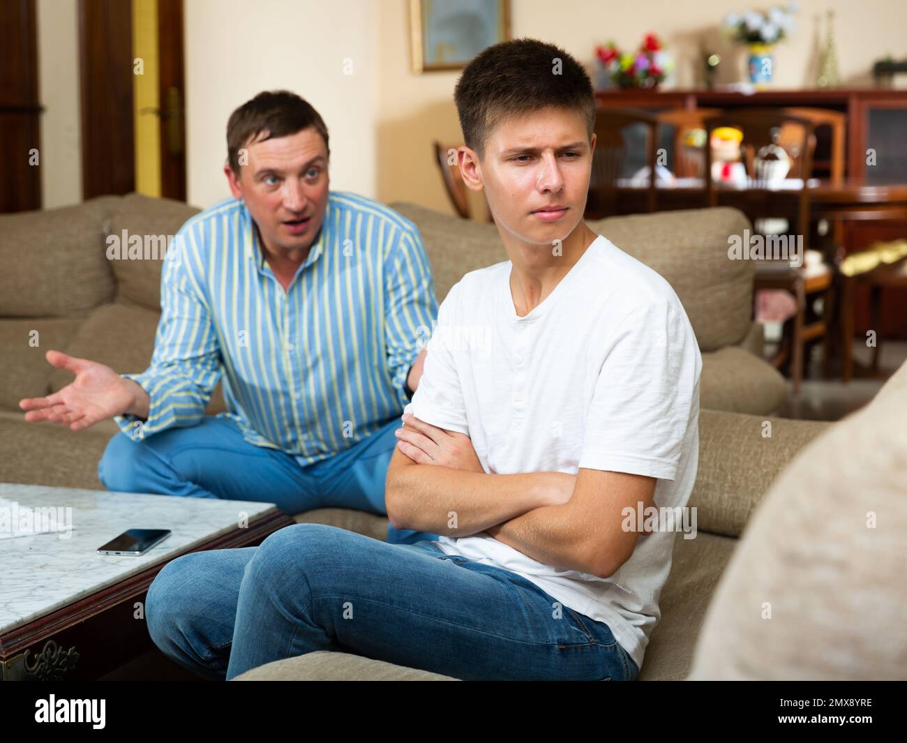 Upset teenager scolded by father Stock Photo