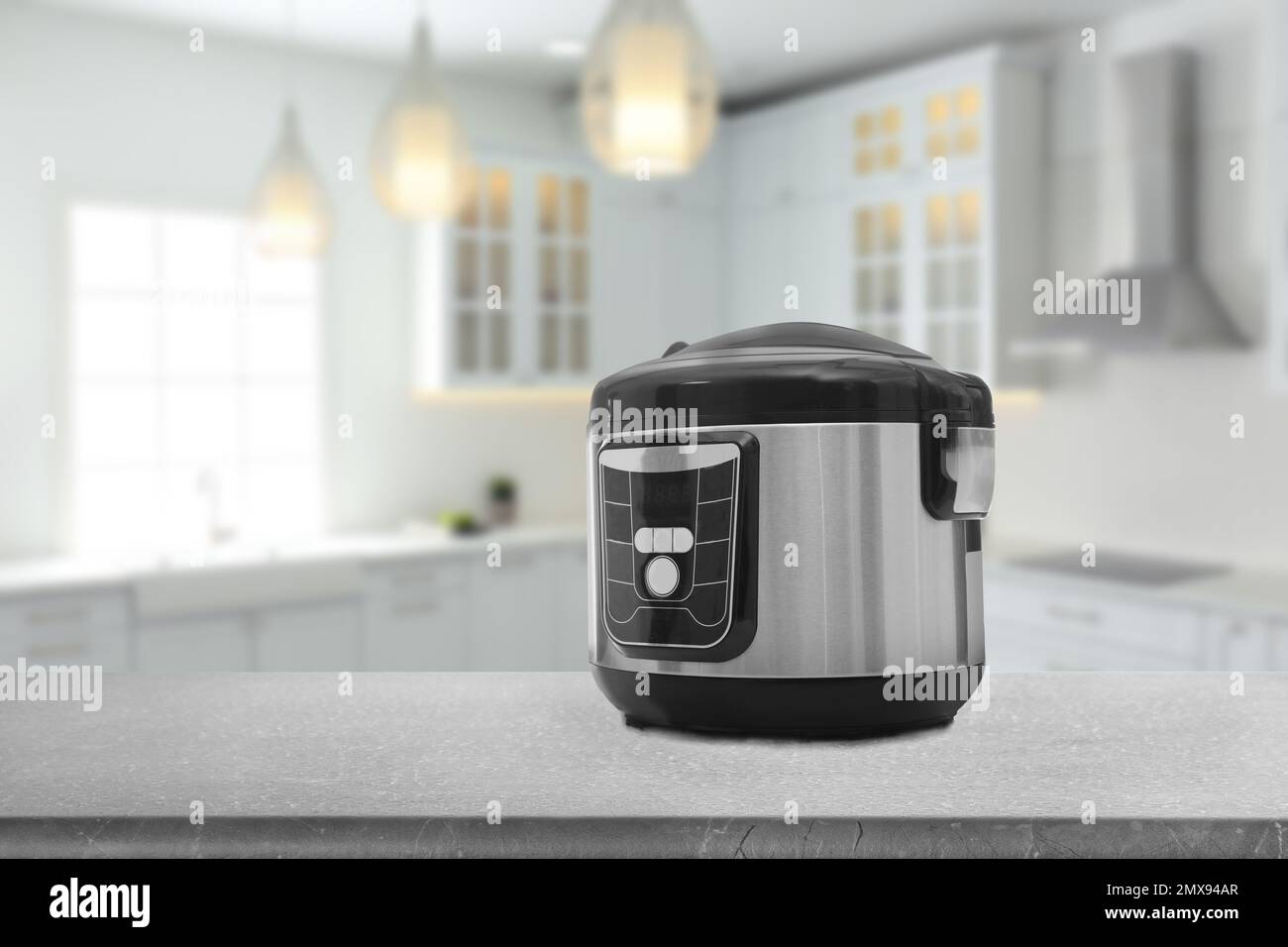 Woman using modern multi cooker in kitchen Stock Photo - Alamy