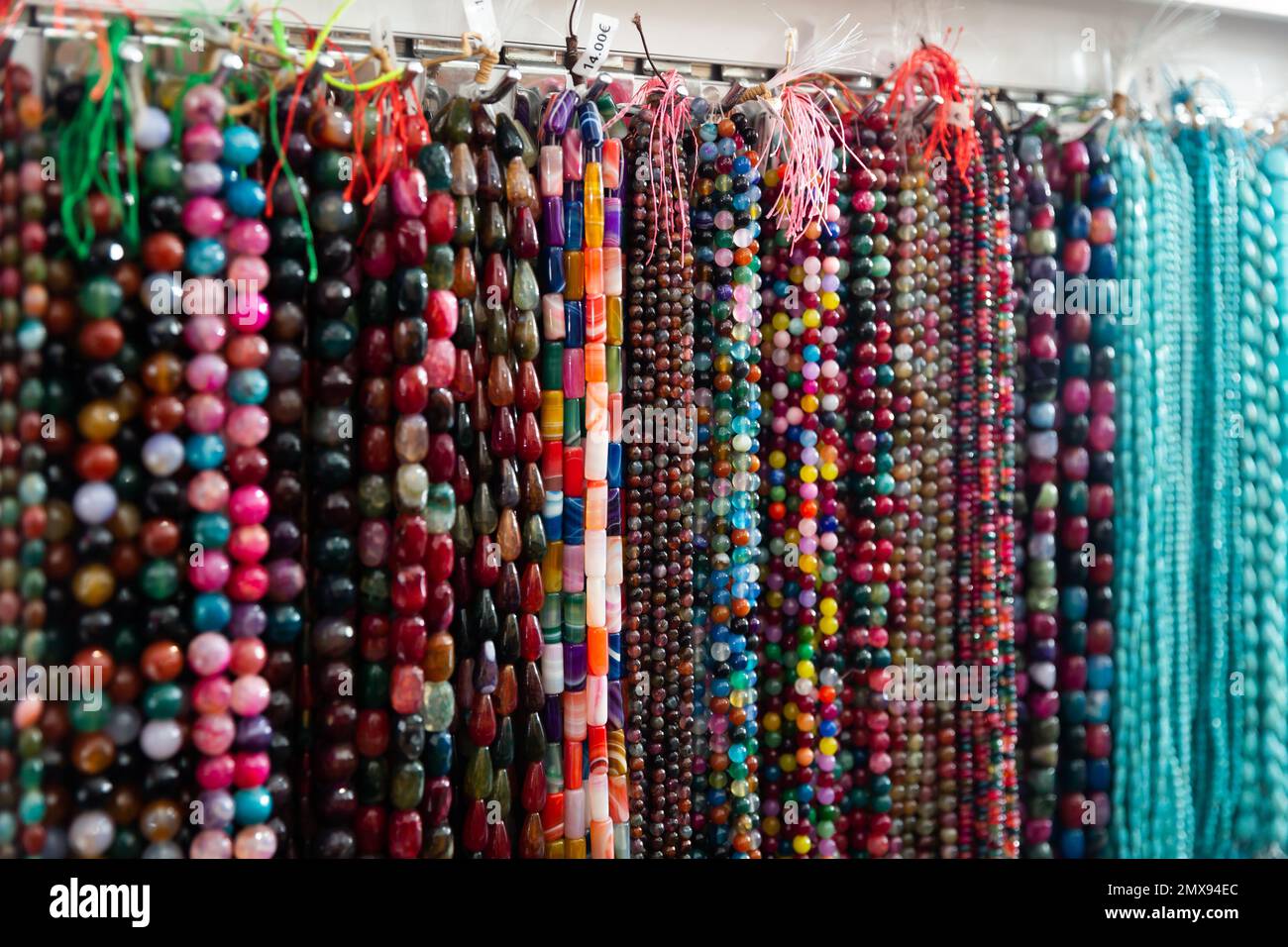 Beads from various gemstones on the showcase of jewelry store Stock ...