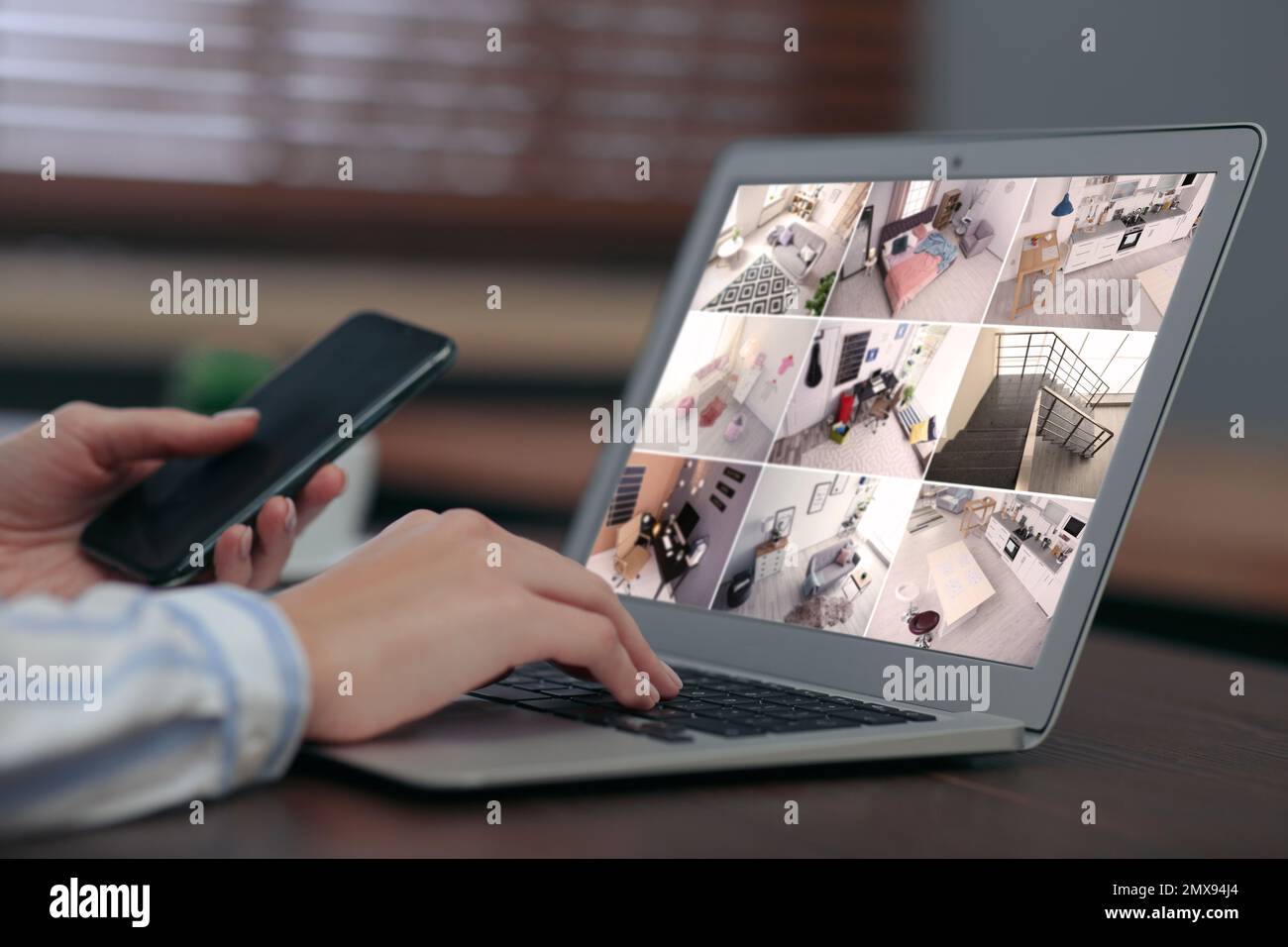 Woman monitoring modern cctv cameras on laptop indoors, closeup. Home