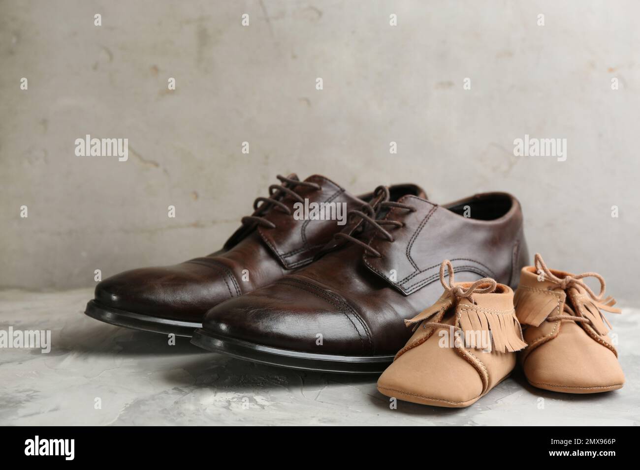 Dad and son;s shoes on grey stone background. Happy Father's Day Stock Photo