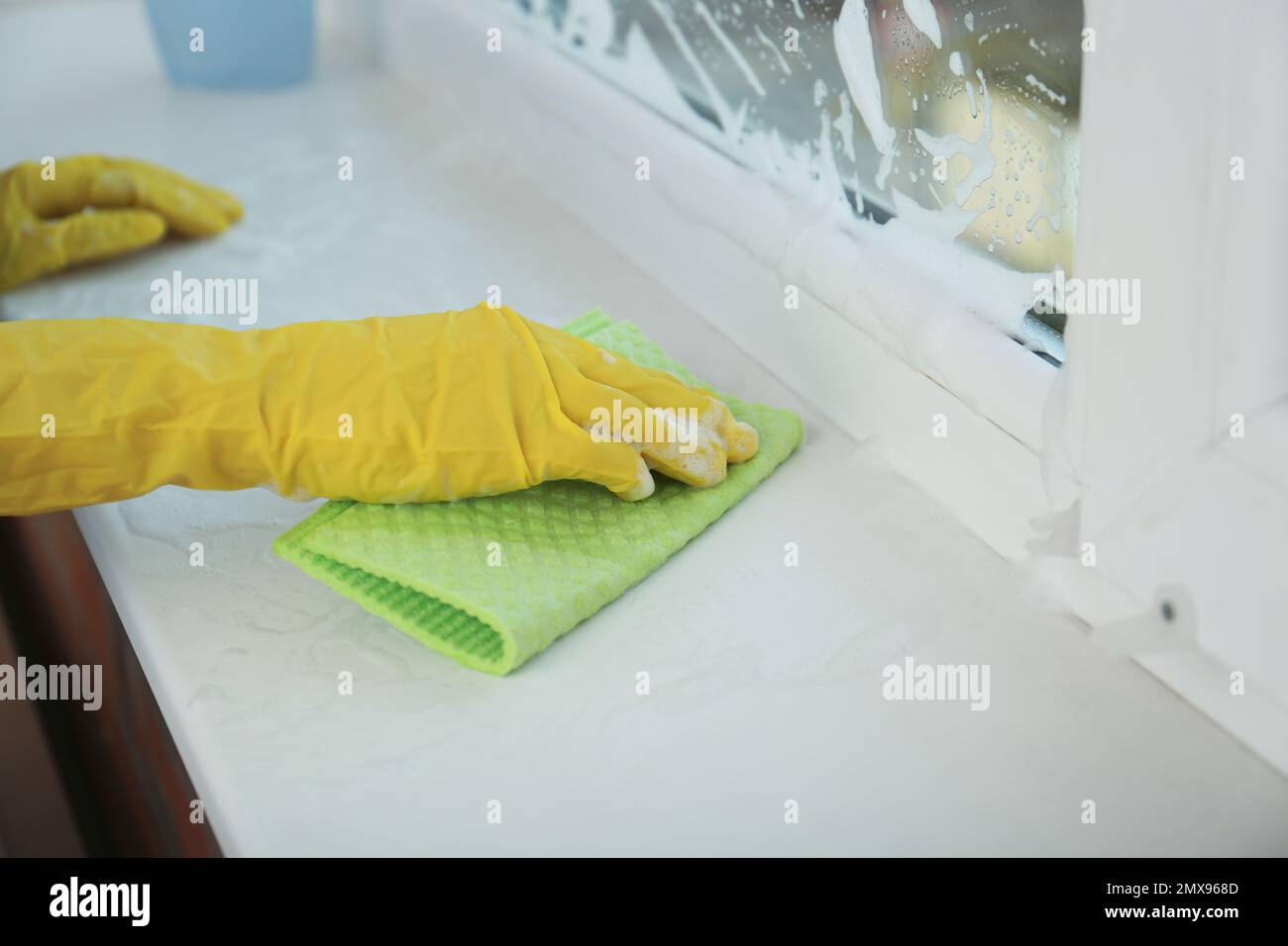 Woman cleaning window sill with rag, closeup Stock Photo - Alamy