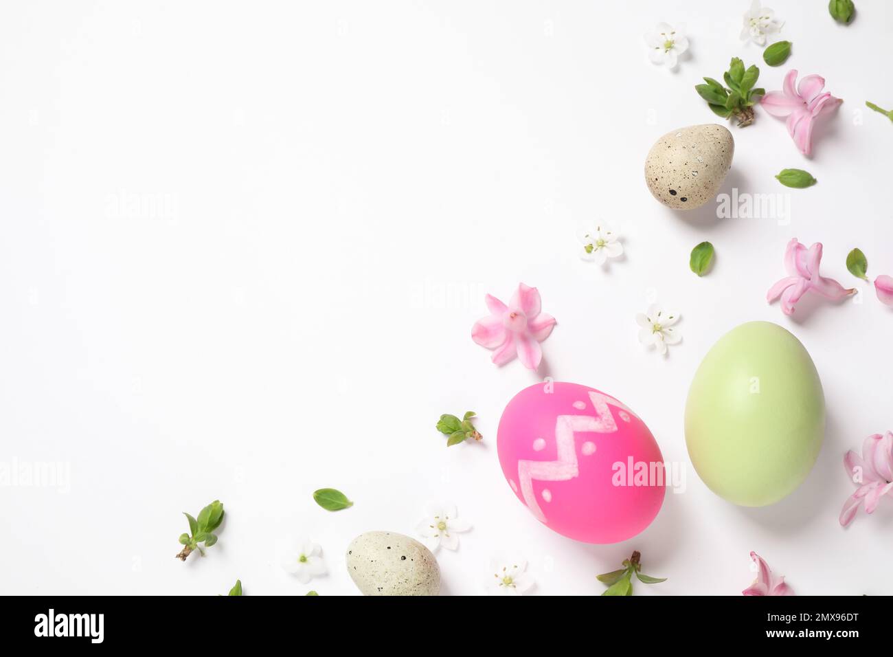 Flat lay composition with Easter eggs on white background. Space for ...