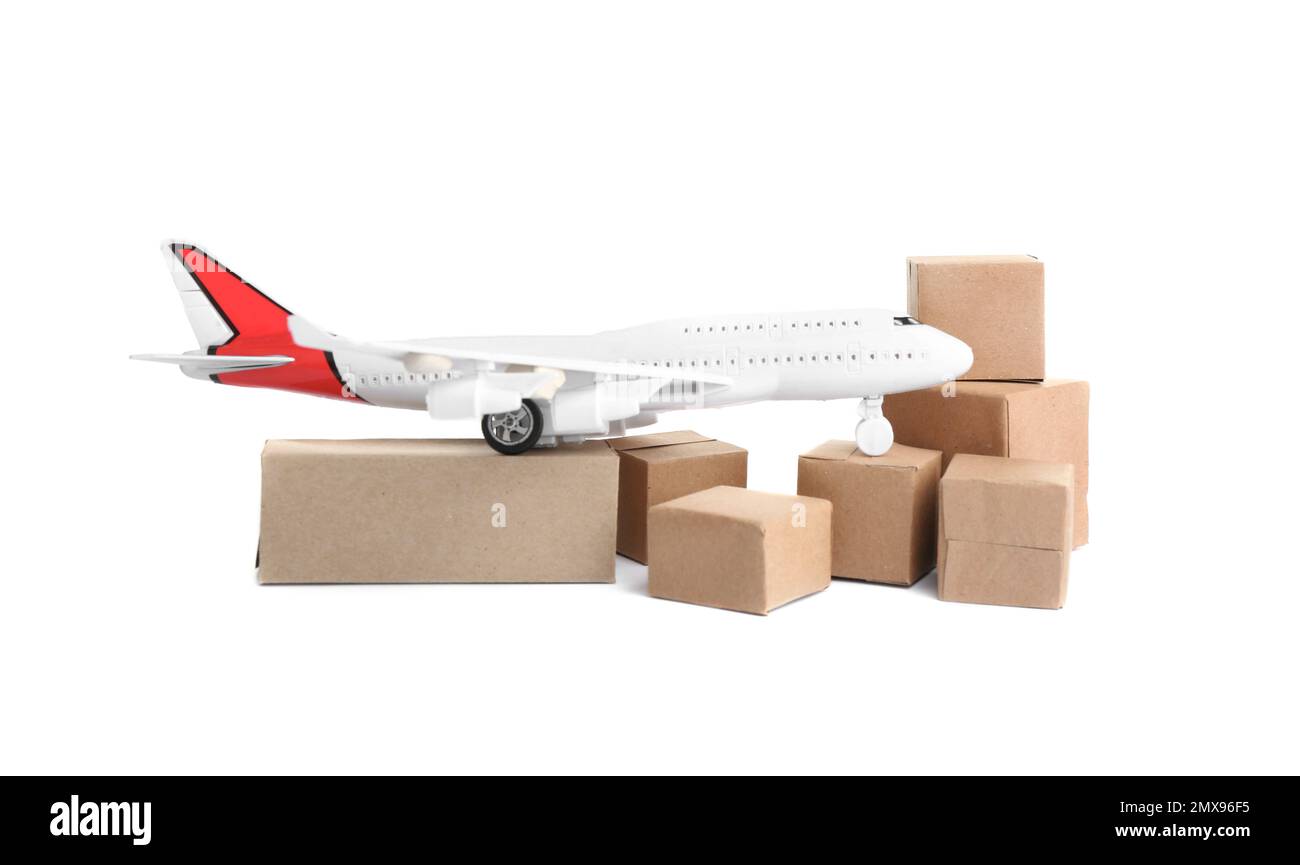 Airplane model and carton boxes on white background. Courier service