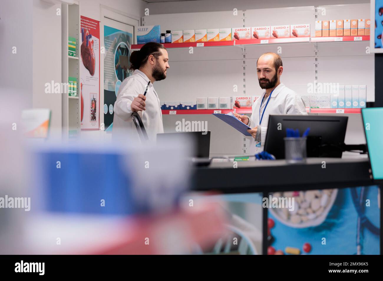 Drugstore workers in white coat maintains an inventory of all the