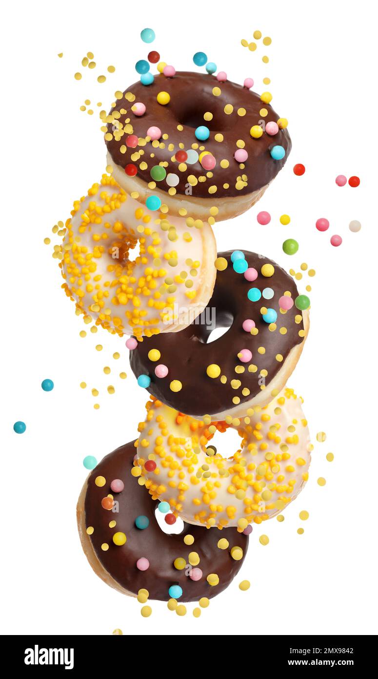 Set of falling delicious donuts on white background Stock Photo - Alamy
