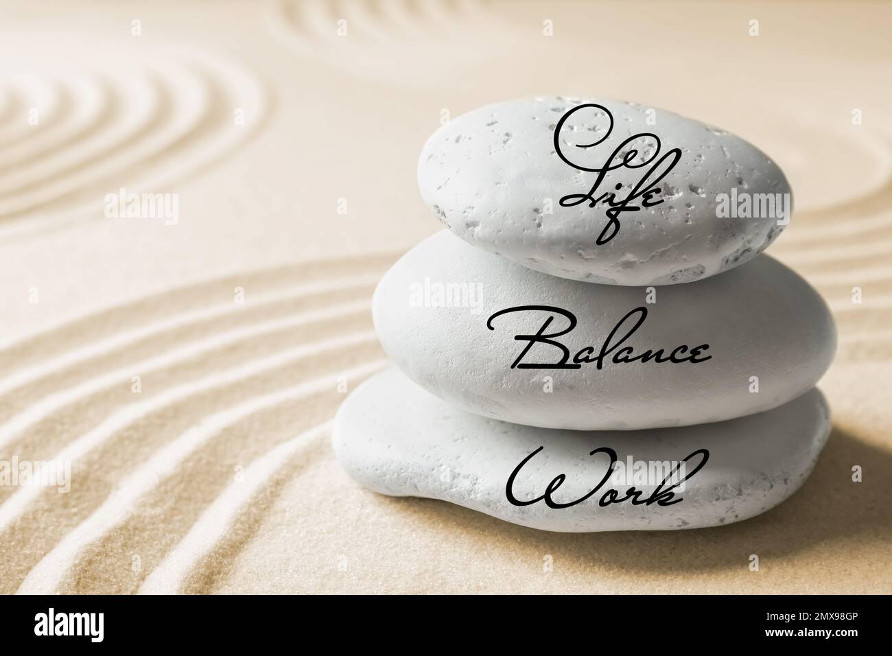 Work-life balance concept. Stacked stones on sand with pattern Stock ...