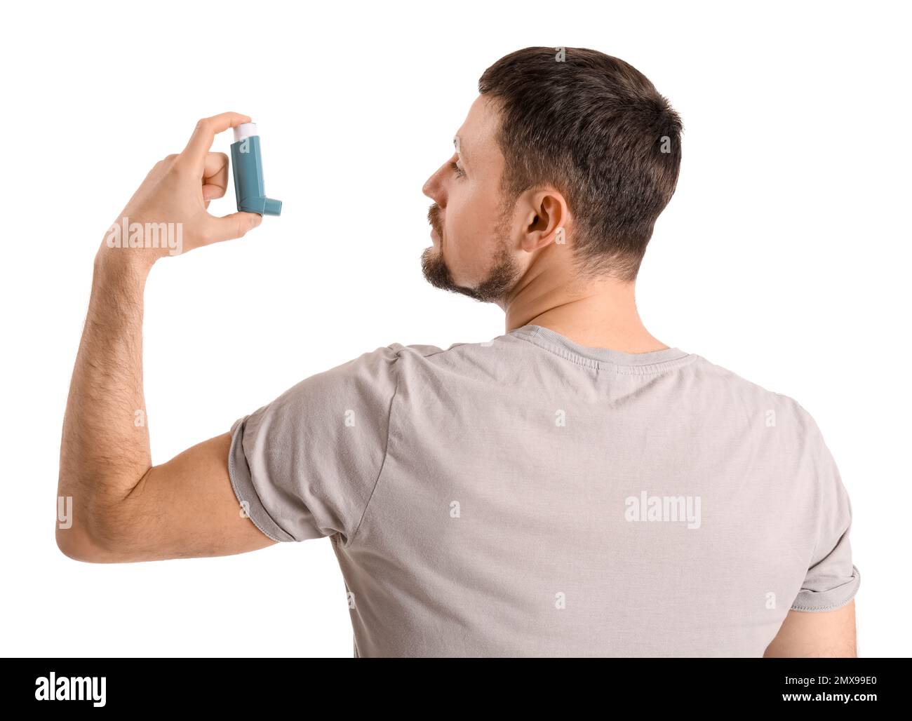 Man with inhaler on white background Stock Photo - Alamy