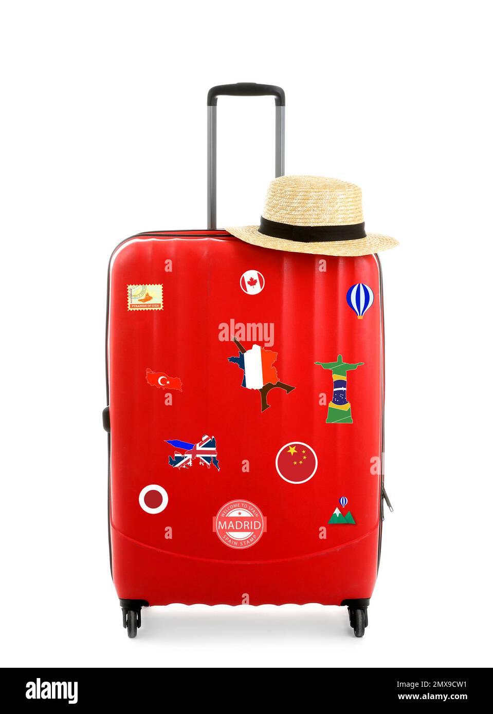Red suitcase with travel stickers on white background Stock Photo Alamy
