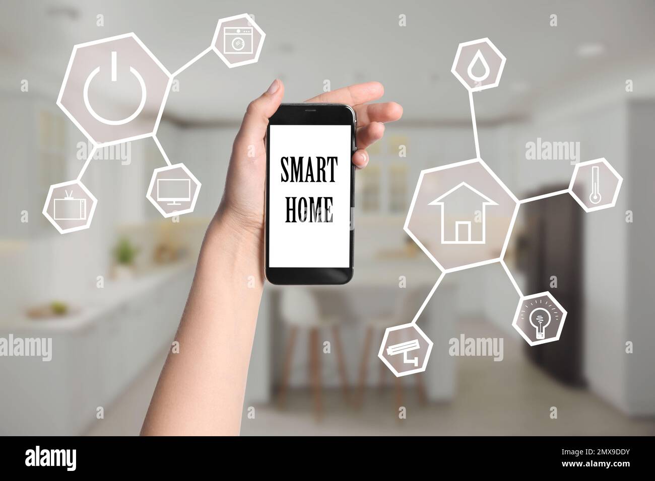 Woman using phone application for controlling smart home indoors, closeup Stock Photo