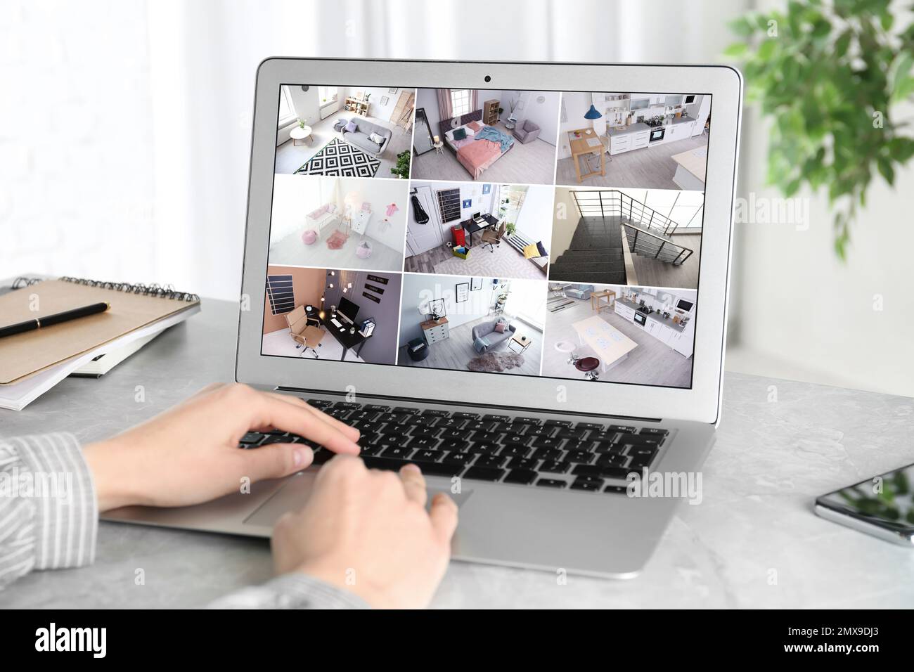 Woman monitoring modern cctv cameras on laptop indoors, closeup. Home