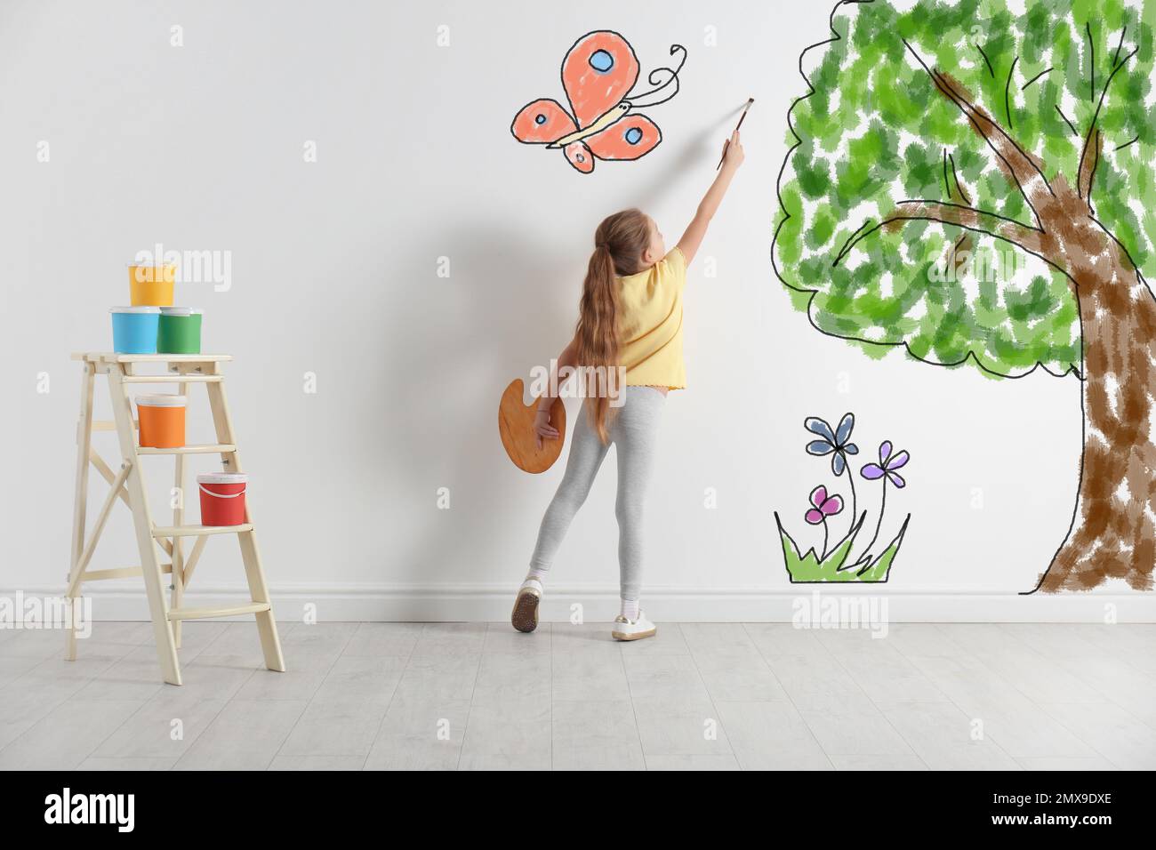 Cute child drawing nature on white wall indoors Stock Photo - Alamy