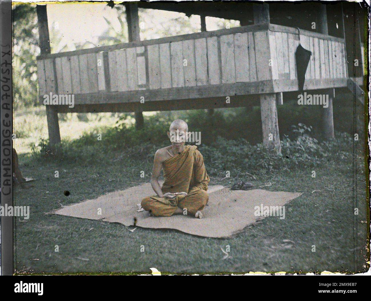Angkor Vat (?), Cambodia, Indochina A bonze seated in meditation on a mat, near the bonzerie , Léon Busy in Indochina Stock Photo