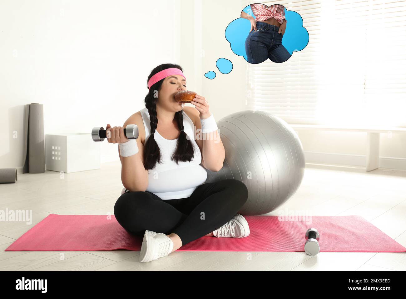 Overweight woman dreaming about slim body while eating bun at gym Stock Photo