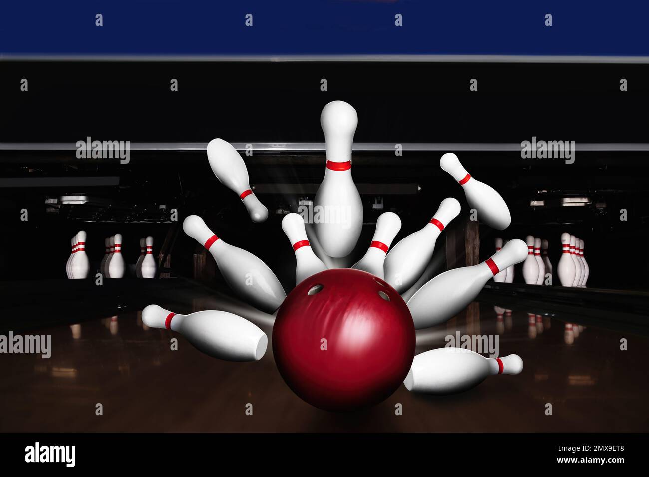 Bowling ball bouncing pins. Successful hit strike Stock Photo Alamy