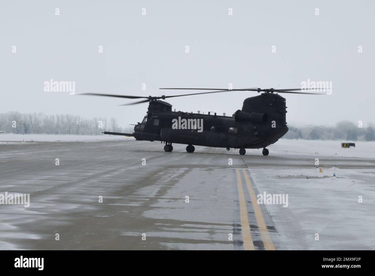 A U.S. Army MH-47G Chinook helicopter taxis on the flight line at Grand Forks Air Force Base, North Dakota, Jan 20. 2023. About 70 members from the 4th Battalion, 160th Special Operations Aviation Regiment assigned to Joint Base Lewis-McChord, Washington, traveled to Grand Forks AFB with several Chinooks to conduct cross-arms training and operations in arctic conditions. (U.S. Air Force Photo by Airman Colin Perkins) Stock Photo