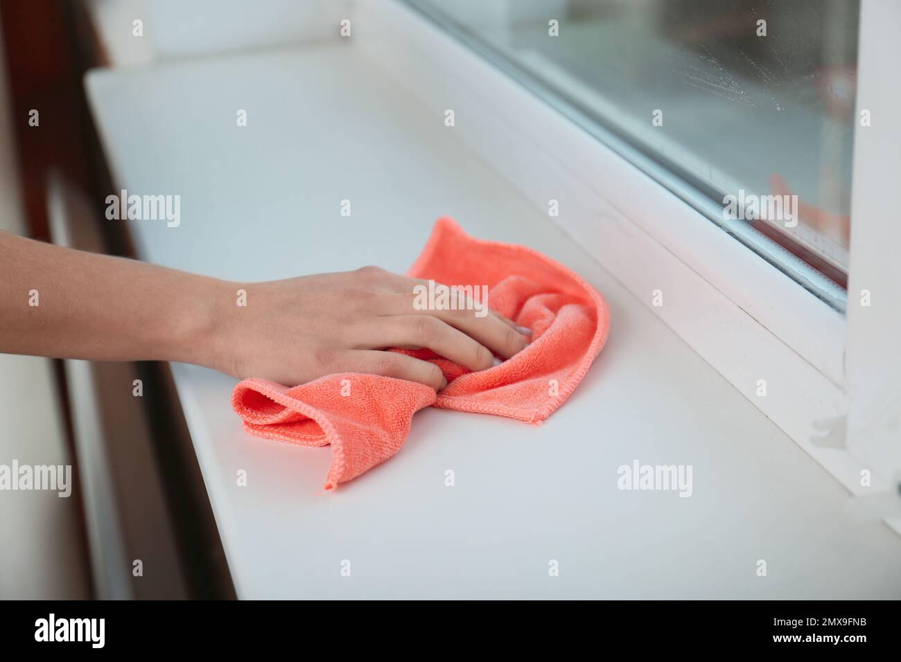 Woman cleaning window sill with cloth, closeup Stock Photo - Alamy