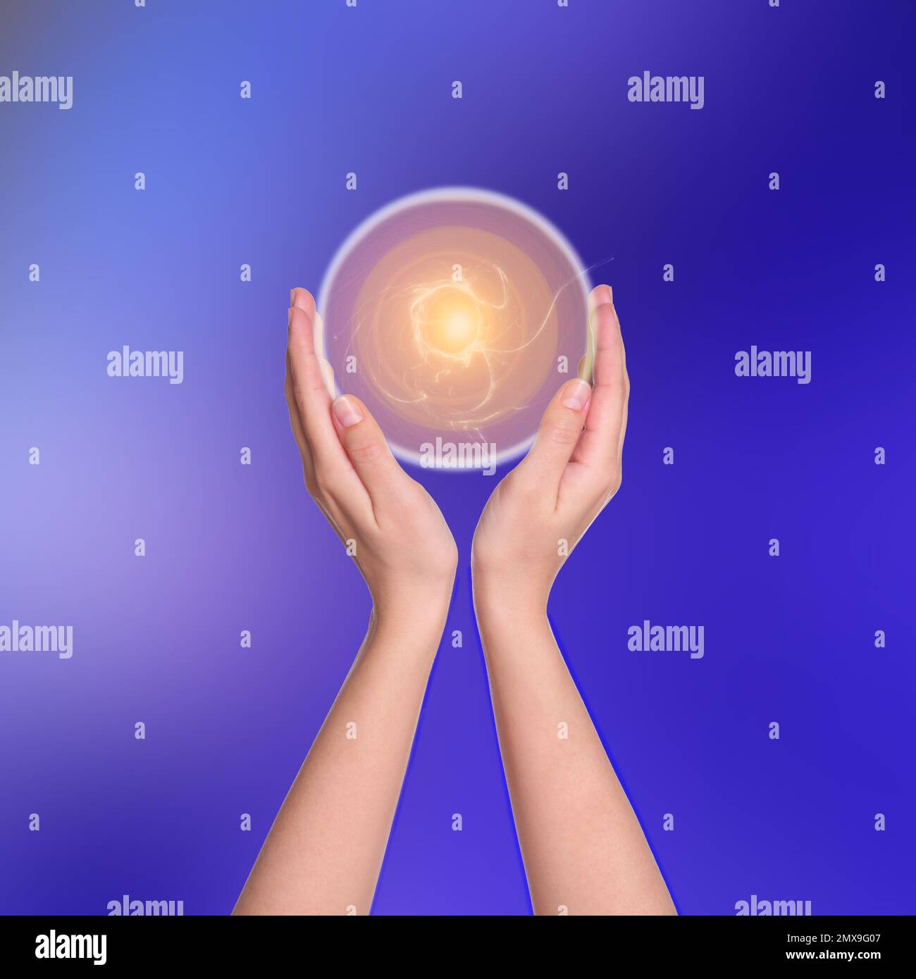 Woman holding concentrated healing energy in her hands, closeup Stock Photo