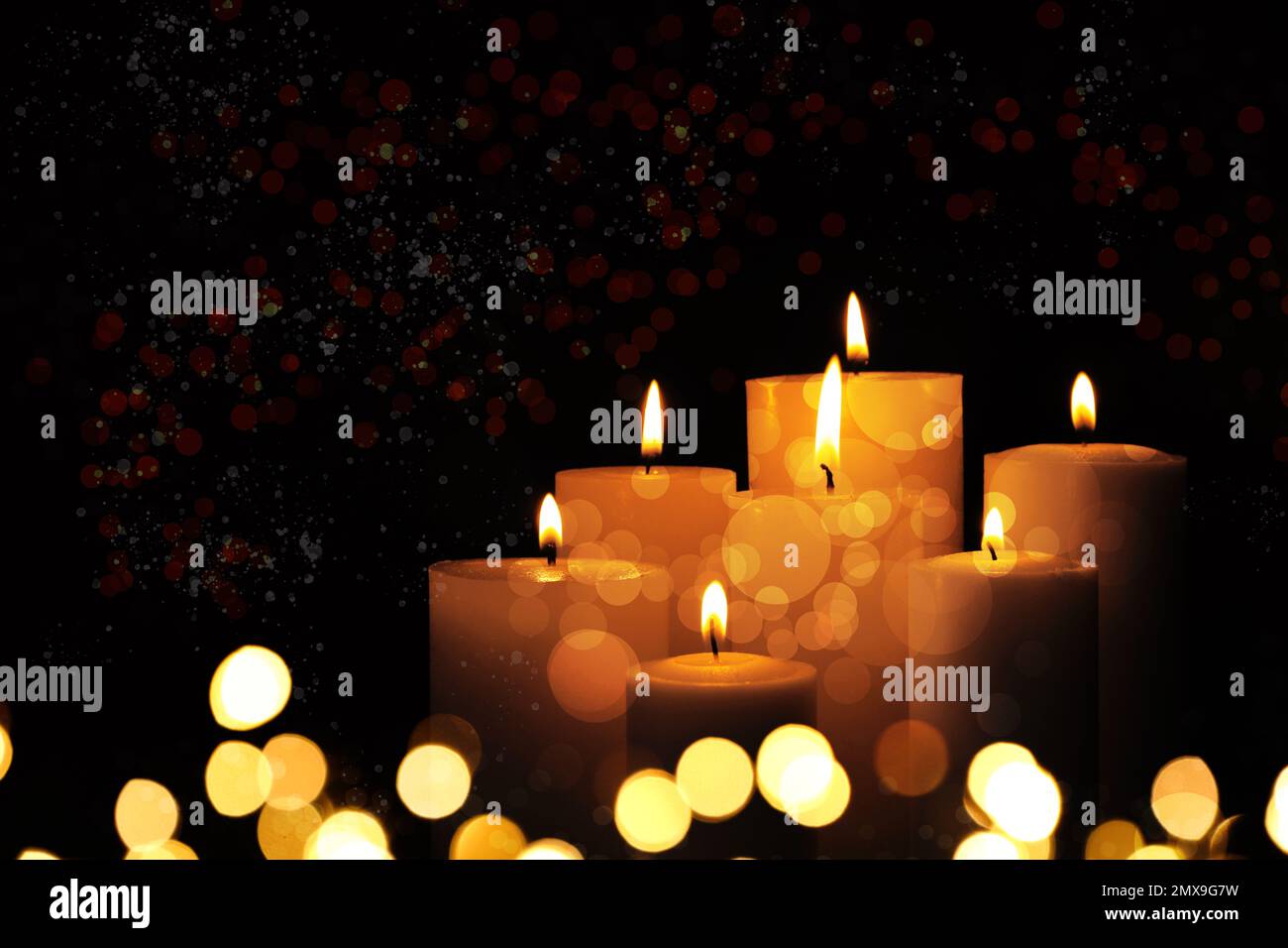 Burning candles on dark background, bokeh effect Stock Photo - Alamy