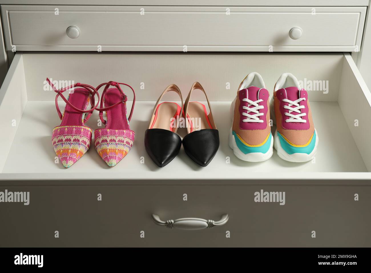 Different women s shoes in open drawer. Footwear storage Stock