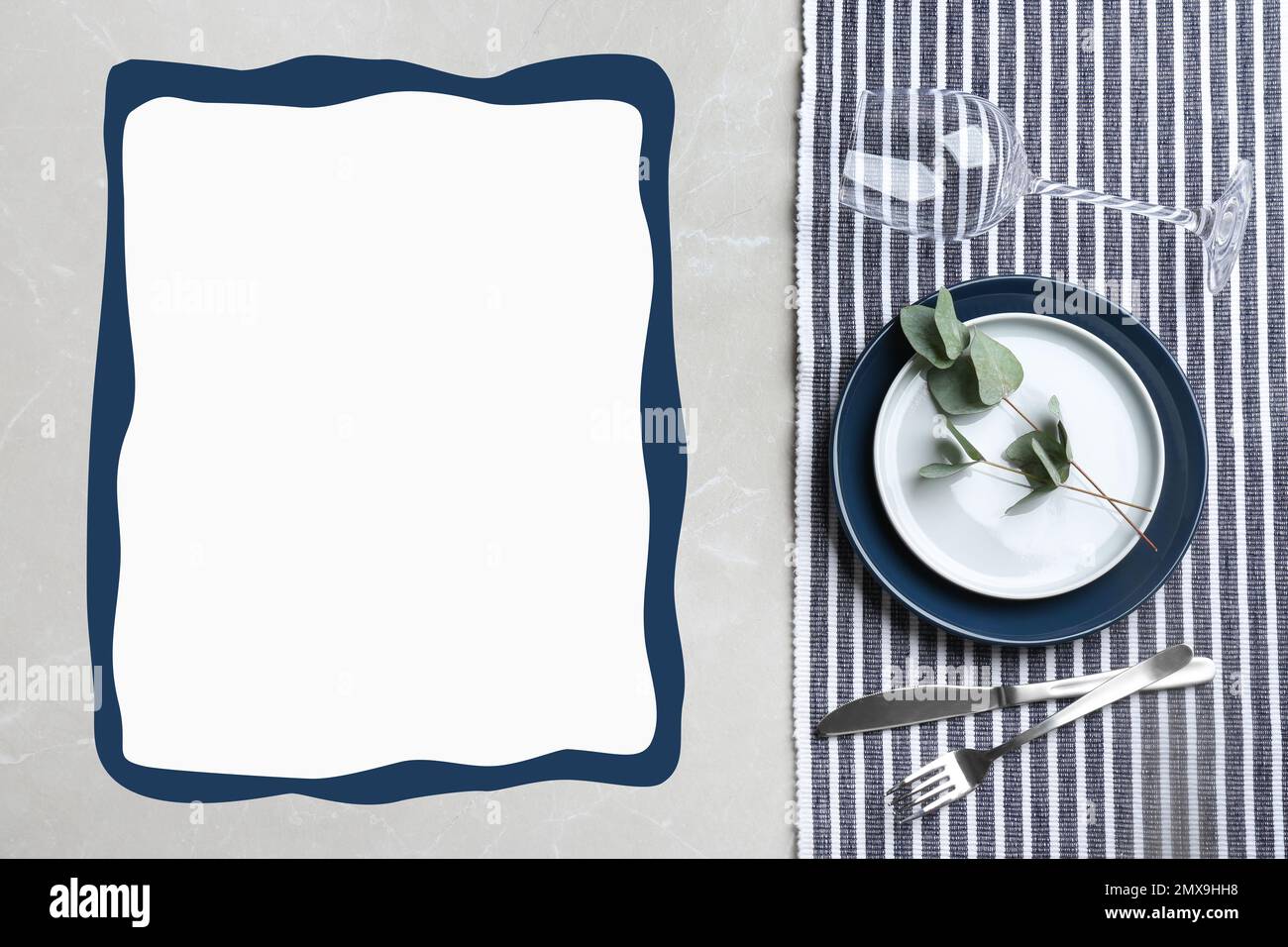 Elegant table setting and empty menu on grey marble table, flat lay. Space for text Stock Photo