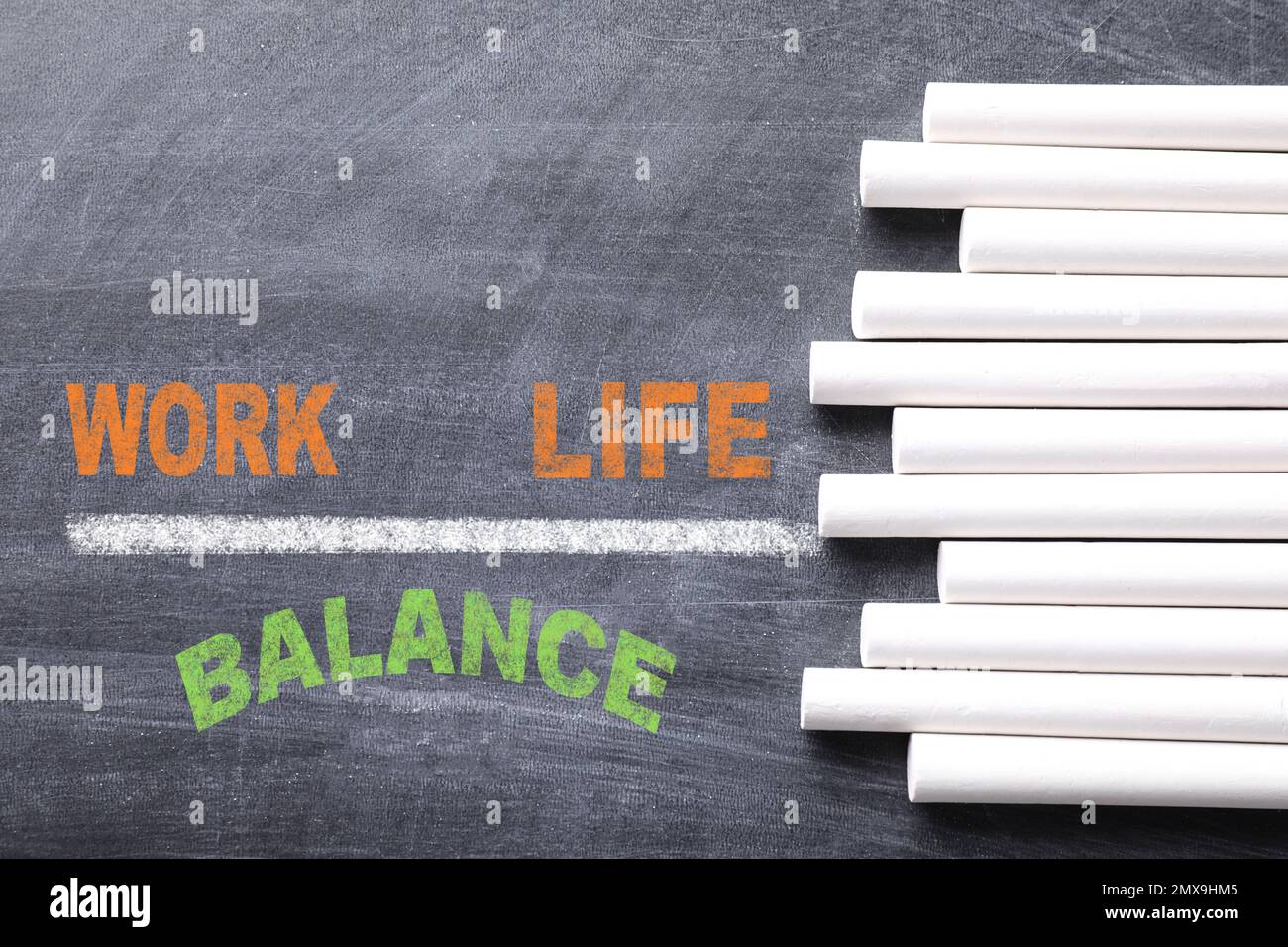 Work-life balance concept. Pieces of chalk on blackboard, top view ...