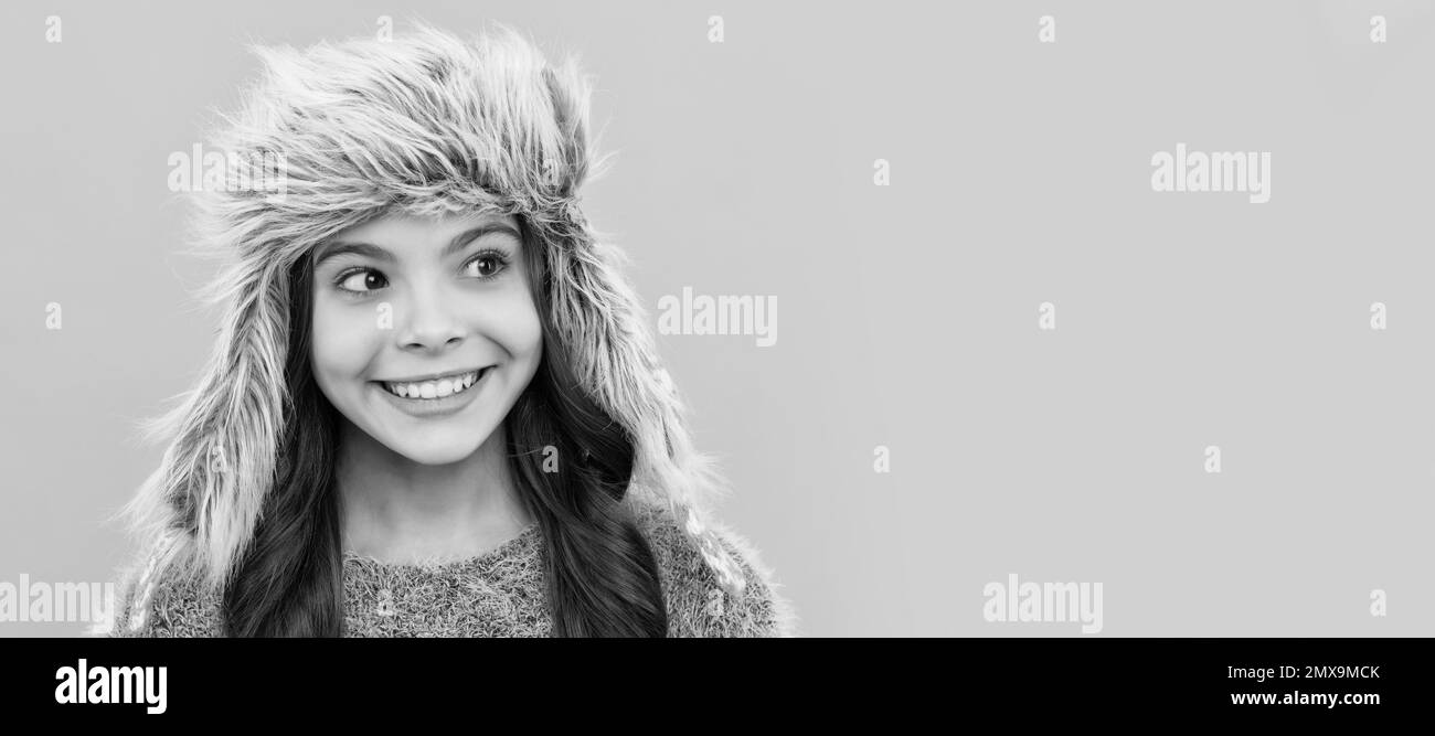 face of child wearing warm clothes. express positive emotion. winter fashion. Child face, horizontal poster, teenager girl isolated portrait, banner Stock Photo