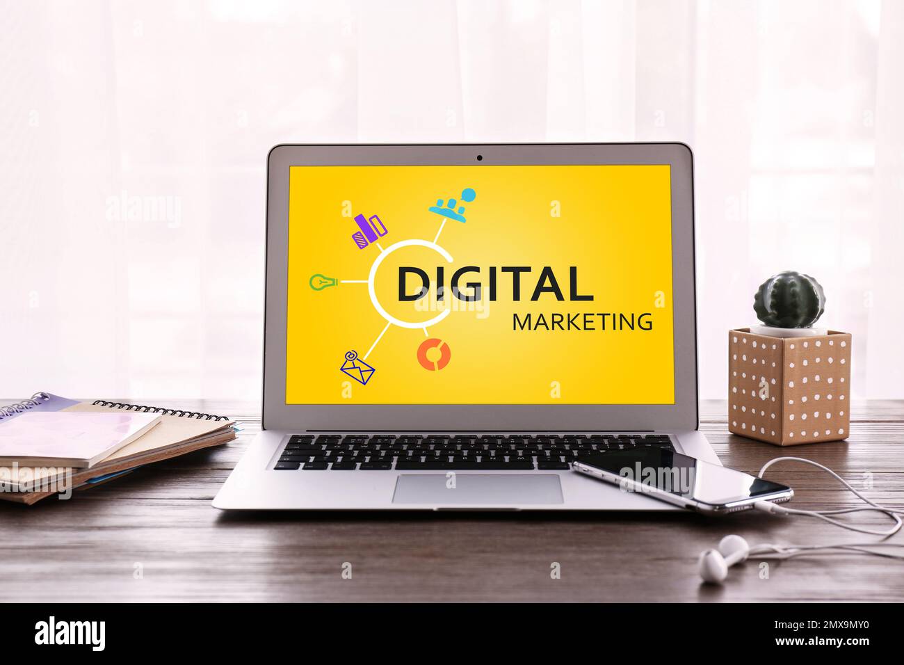 Digital marketing concept. Modern laptop on wooden table Stock Photo