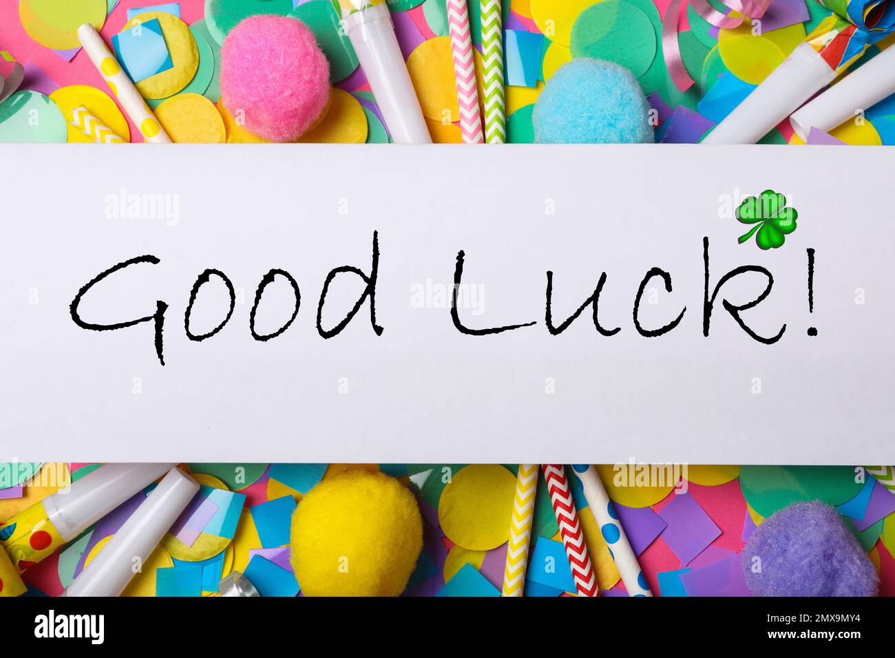 Phrase GOOD LUCK written on white note and party decor, top view Stock Photo