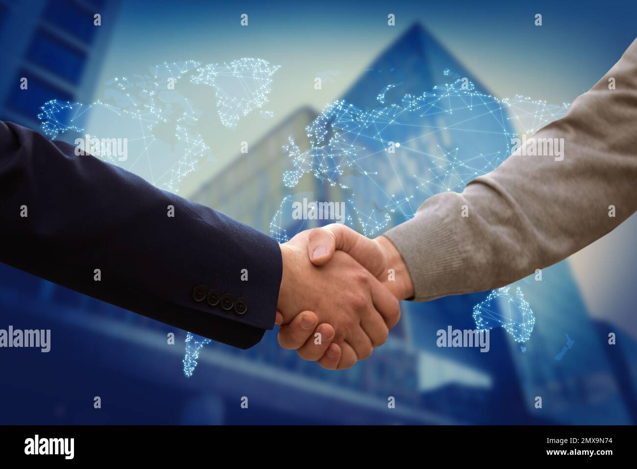 Closeup view of partners shaking hands and world map. Business values Stock Photo