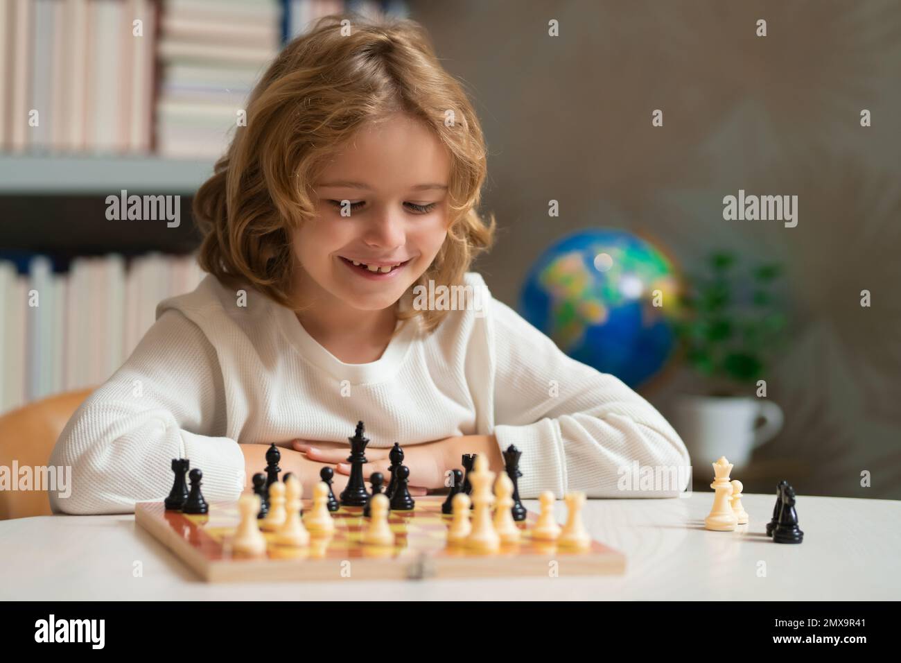 Chess game for children. Kid playing chess. Games and activities for children Stock Photo