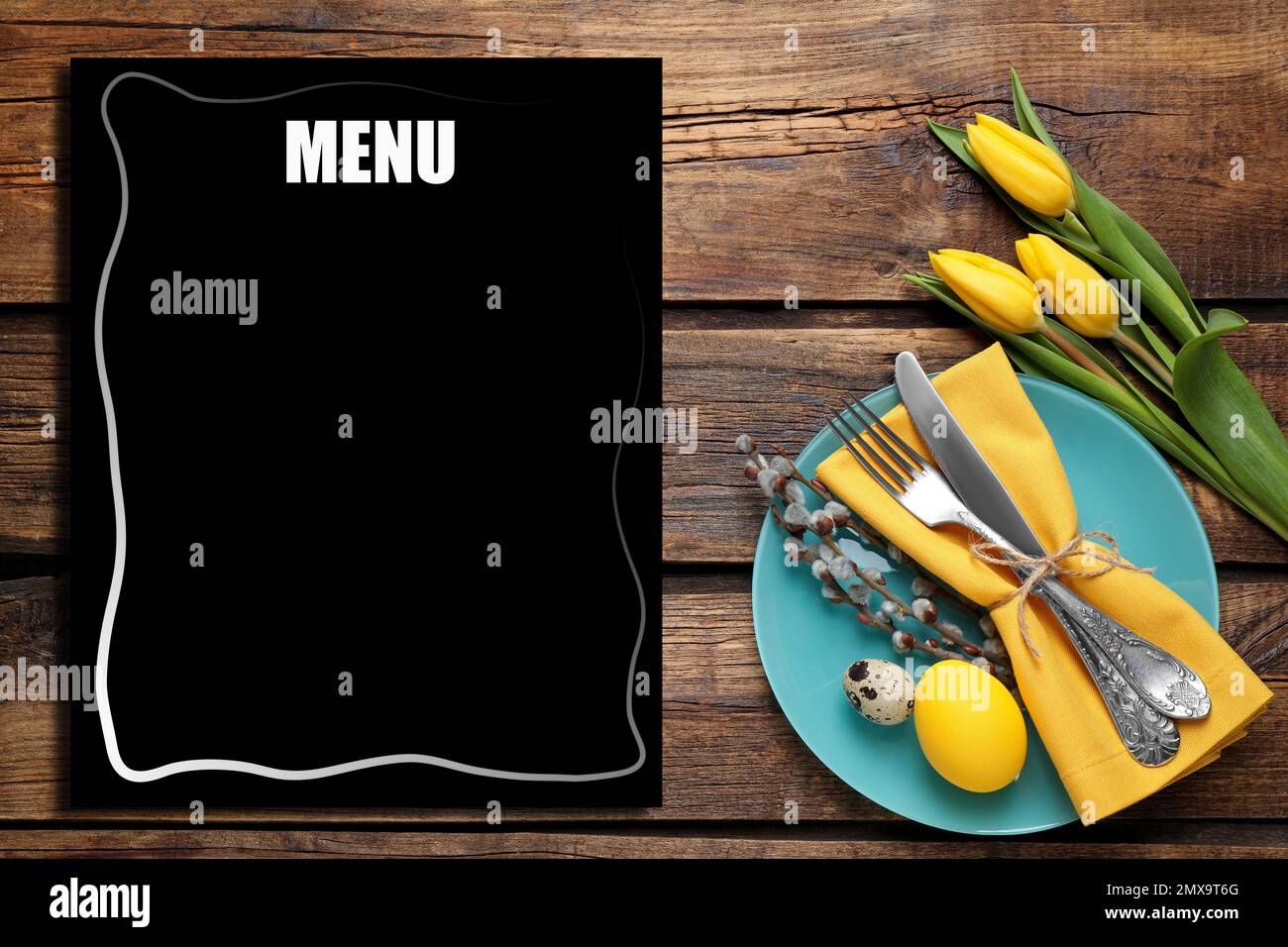 Festive table setting with tulips and empty menu, flat lay. Space for text Stock Photo