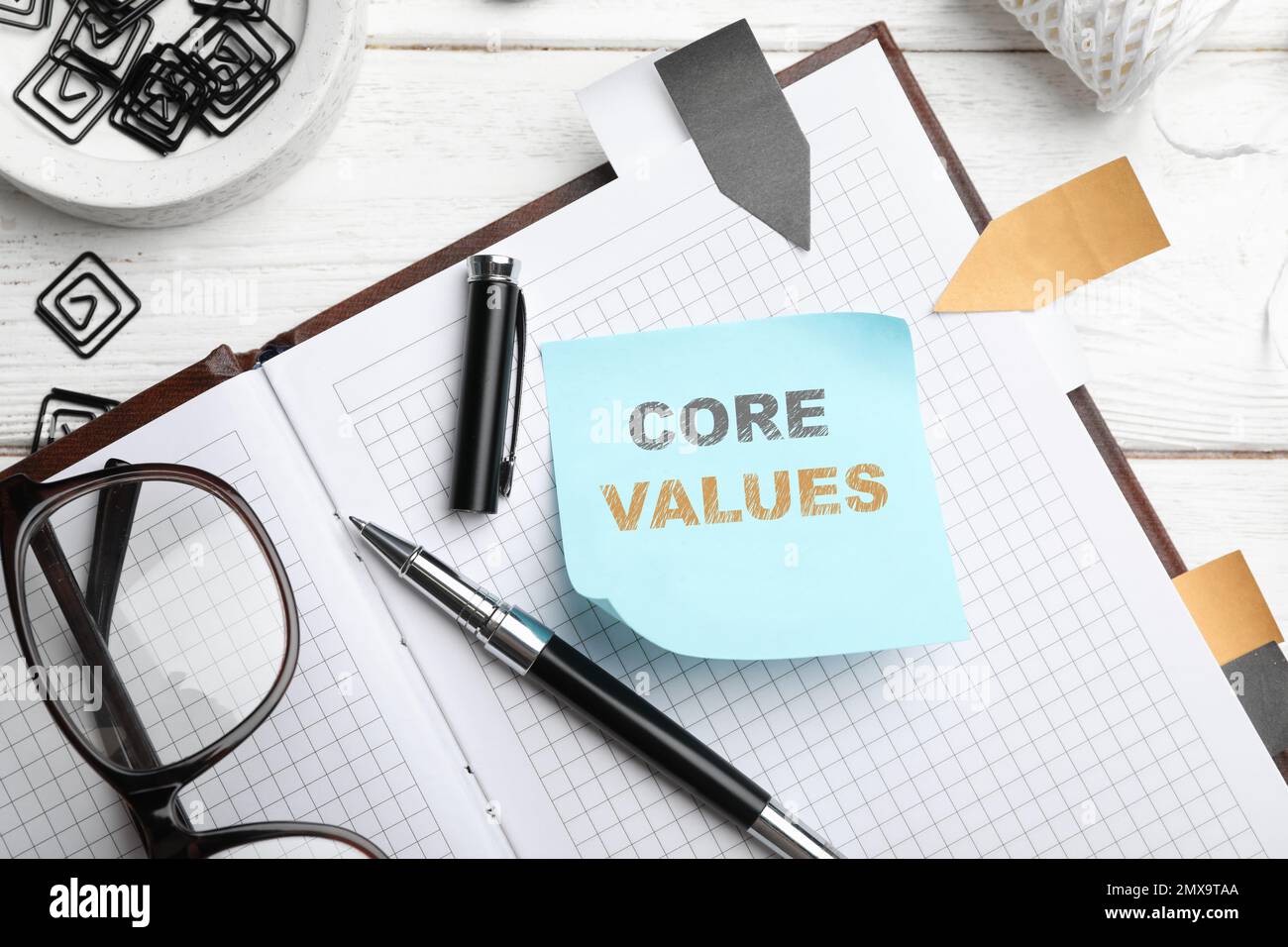 Core values concept. Flat lay composition with stationery on white wooden table Stock Photo