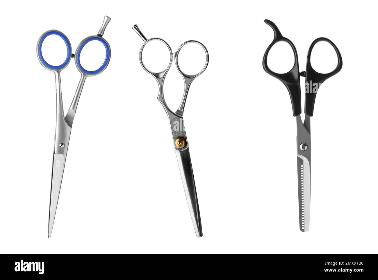 Set of different professional hairdresser scissors on white background