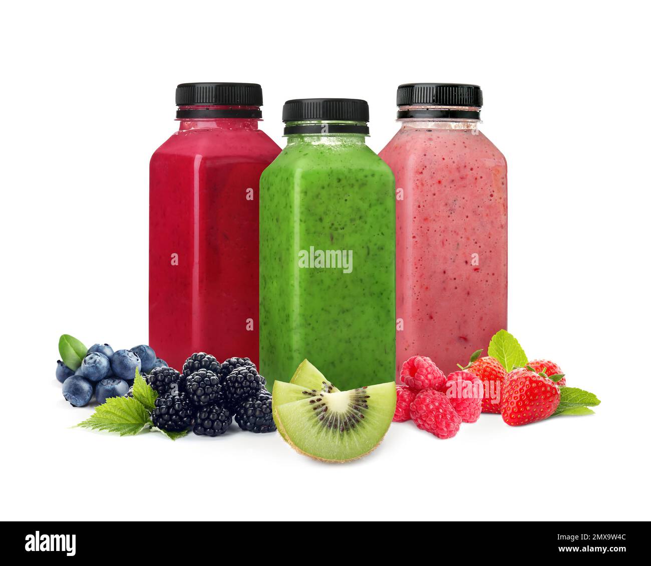 Different delicious smoothies in bottles on white background Stock