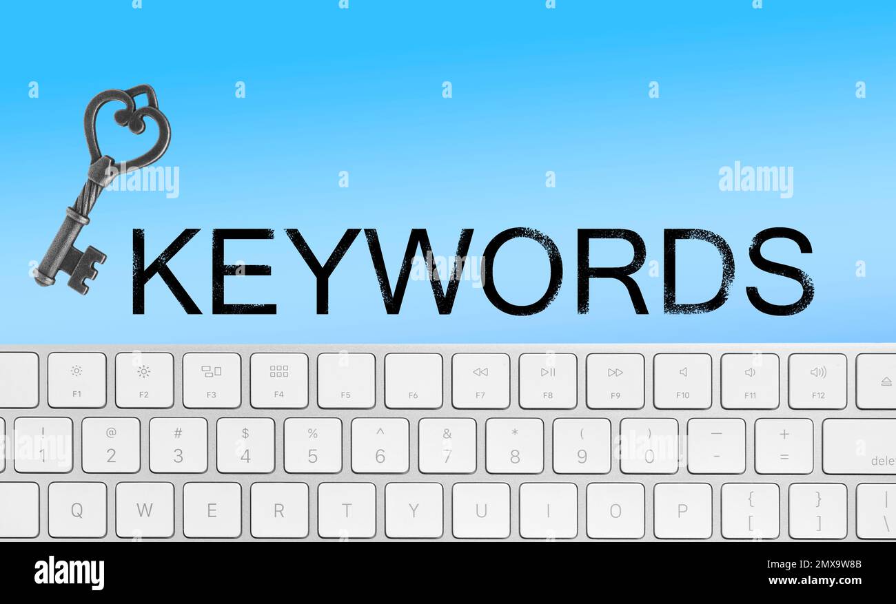 Word Keywords, computer keyboard and key on light blue background. SEO direction Stock Photo