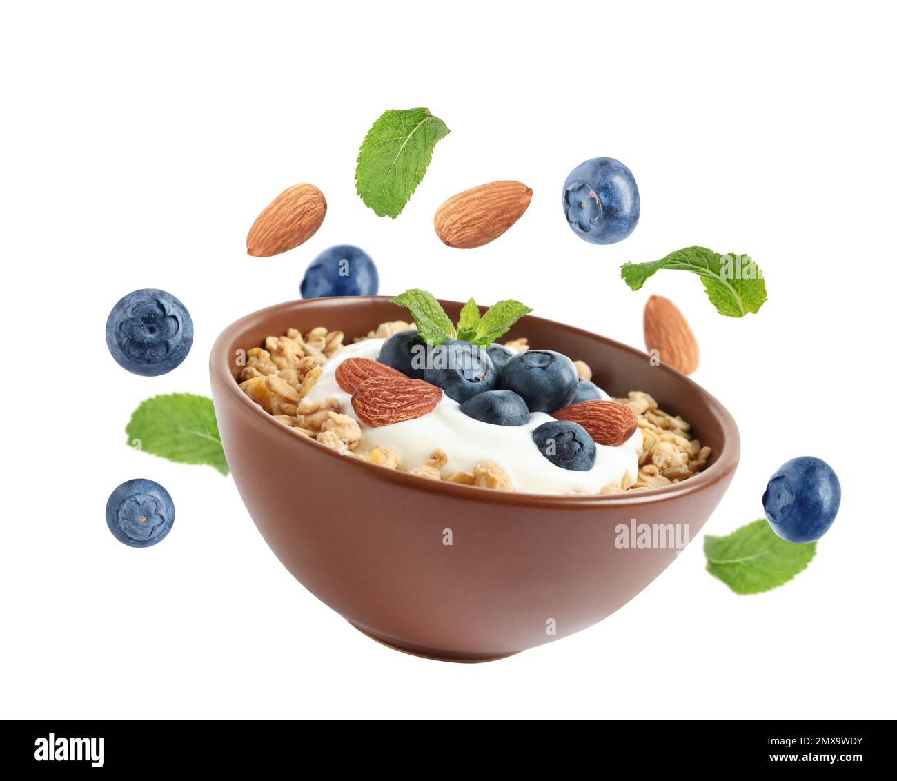 Tasty oatmeal with blueberries, yogurt and almond on white background Stock Photo