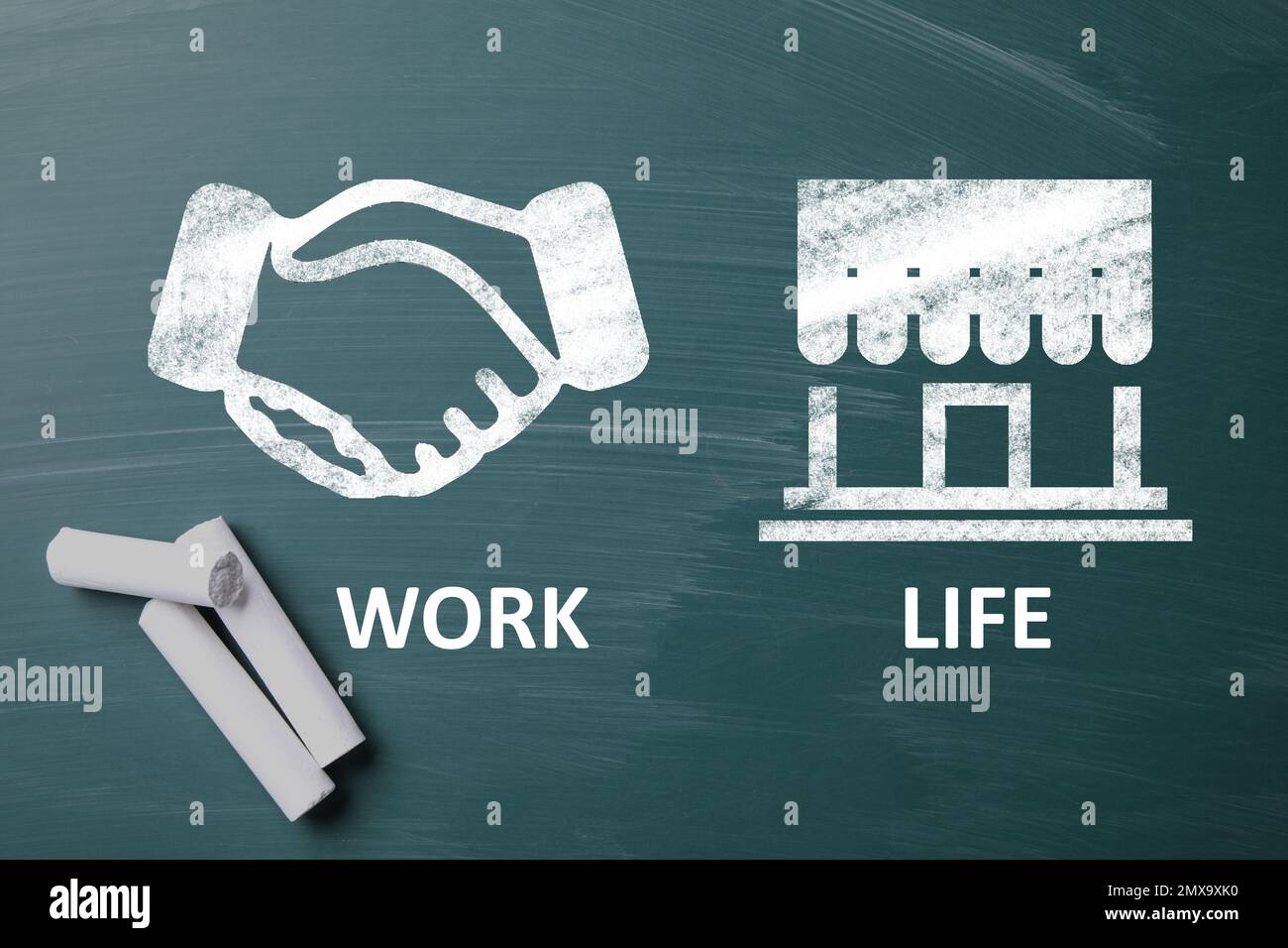 Work-life balance concept. Drawing of handshake and house on chalkboard ...