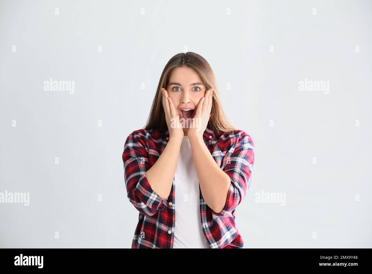Portrait of surprised young woman on white background Stock Photo - Alamy
